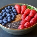 A hearty bowl of oatmeal with berries showcasing what's the healthiest filling breakfast.