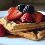 A plate of dietary almond flour waffles topped with fresh berries.